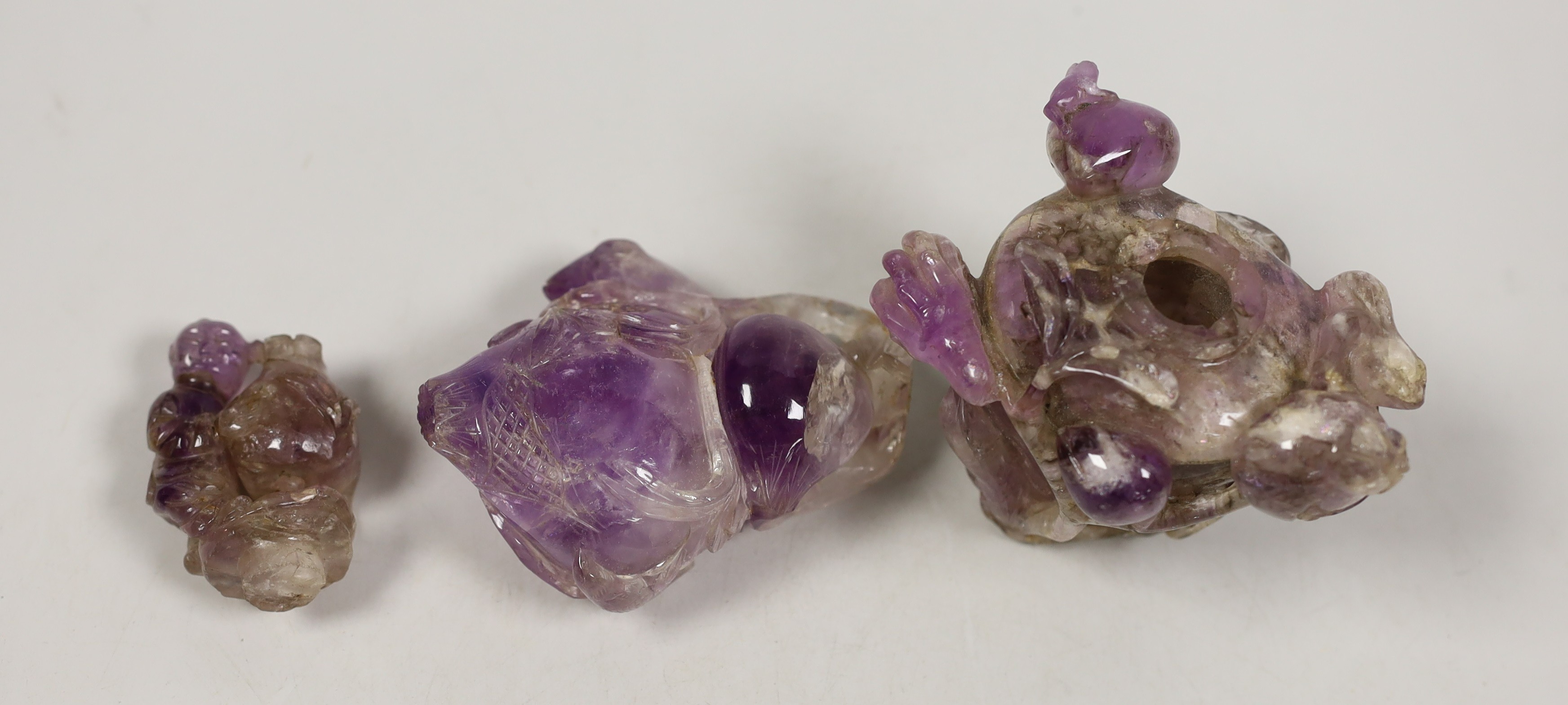 Two Chinese amethyst crystal carvings of peaches and a vase, tallest 8.5 cm